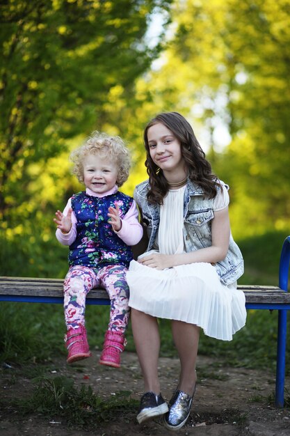 Sisters in the park in the evening of a sunny day in the spring