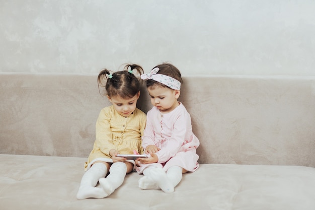 sisters play a game on a smartphone