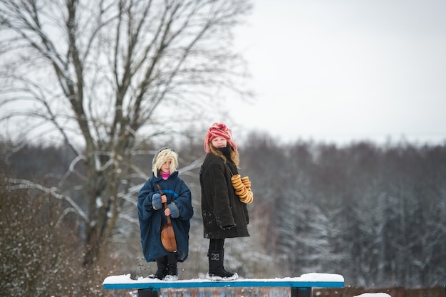 Sisters in winter with balalaika