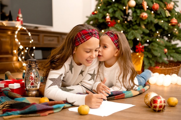 sisters writing letter to Santa Claus