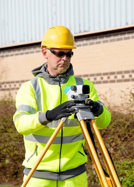 Site engineer installing auto level to do level survey