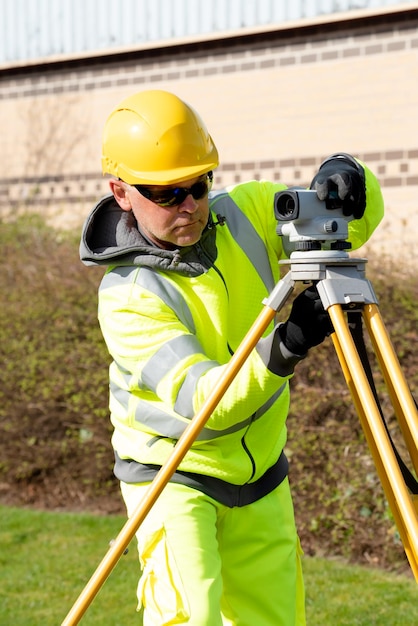 Site engineer installing autolevel to do road level survey