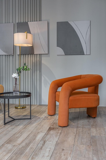 sitting area with two soft stylish armchairs in huge modern spacious apartment with high loft style ceilings wooden decoration and grey walls