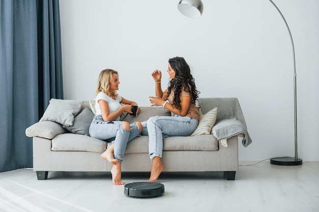 sitting on bed two women is together at home