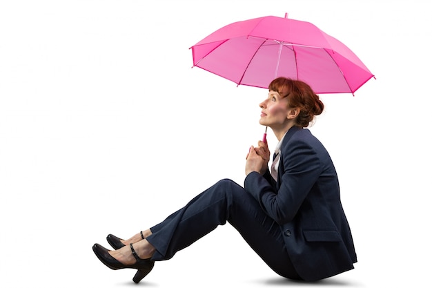 Sitting businesswoman holding pink umbrella