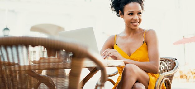 Sitting in a summer cafe typing a message to the teacher The woman is charming and confident working