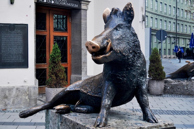 Sitzender Keiler wild boar statue in Neuhauser Strasse Main Shopping Street for german people and foreign travelers travel visit at Munich capital city on November 15 2016 in Bavaria state Germany