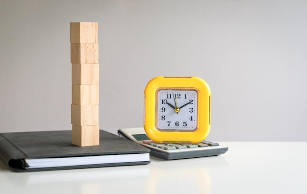 Six blank wooden block cubes stacked on top of a notepad