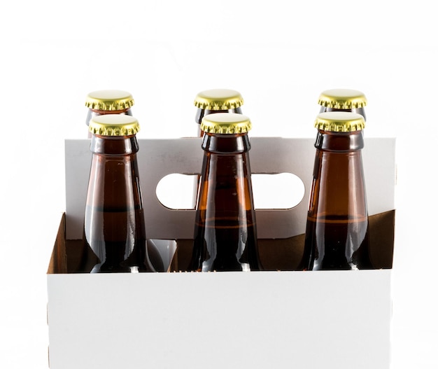 Photo six bottles of beer in cardboard carrier