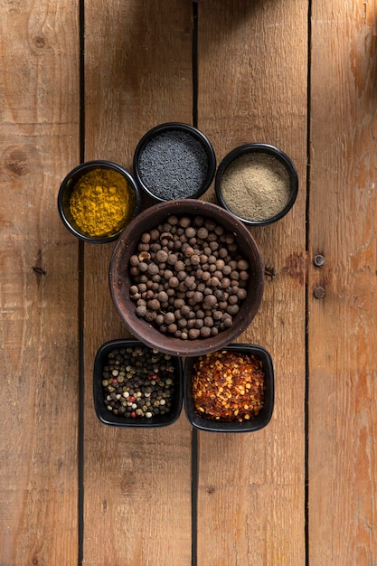 Six bowls of Spices on a Wooden table