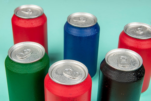 Six cold cans of soda in different colors