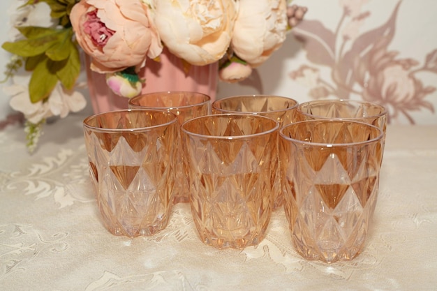 Six glasses with a pink flower in the middle.