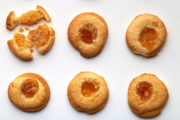 Six handmade cookies with apricot jam arranged in even rows.