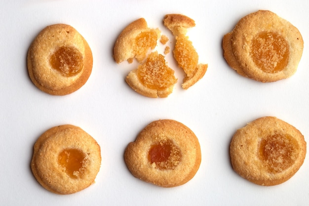 Six handmade cookies with apricot jam arranged in even rows.