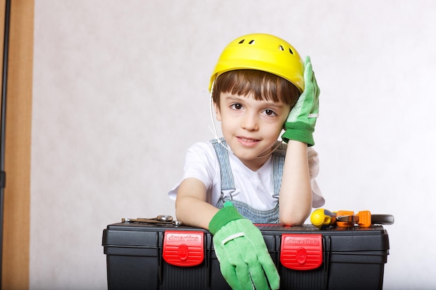 Six years old boy with tool set. Closeup