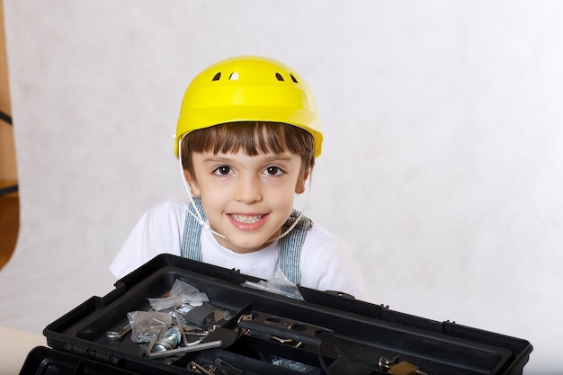 Six years old boy with tool set. Closeup