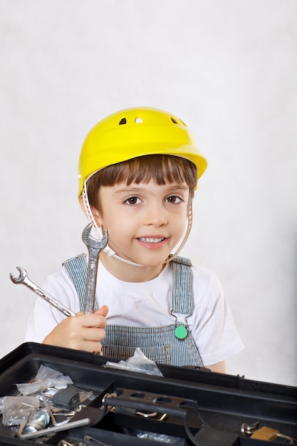 Six years old boy with tool set. Closeup