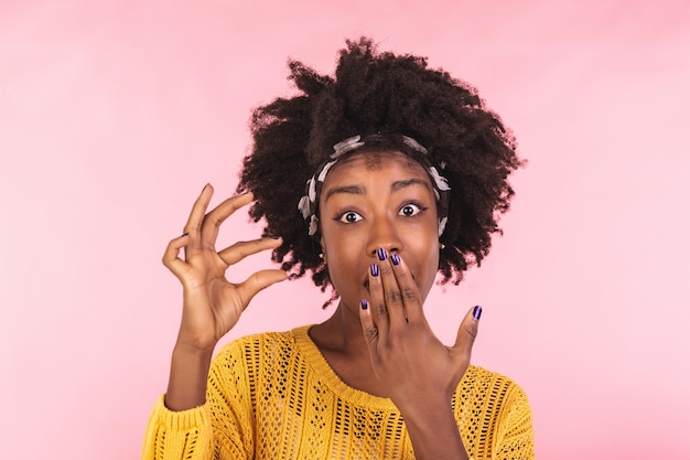 Size matters.   young woman demonstrates very tiny object, smiles positively