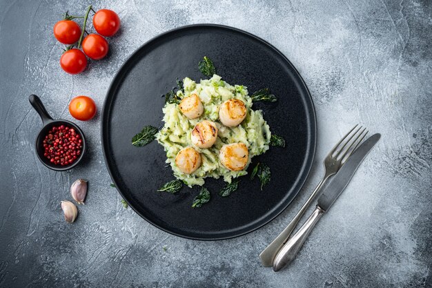 Sizzling seared scallops grilled meal, top view, on grey table