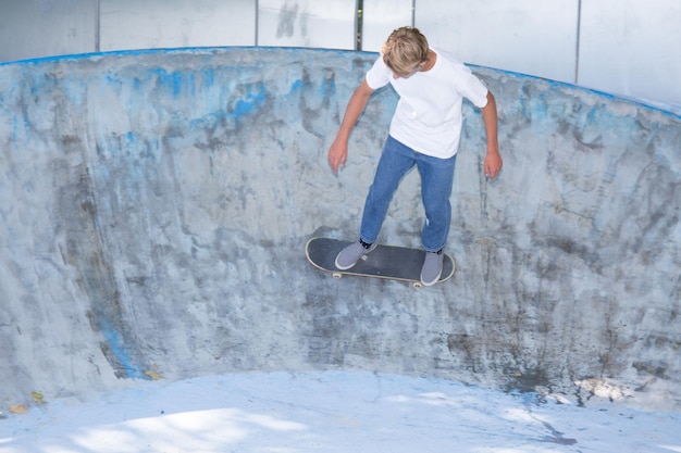 Skateboarder in a concrete pool at skatepark