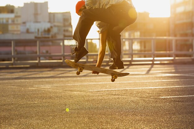 Skateboarder doing a trick at the citys street in summers sunshine