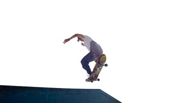 Skateboarder doing a trick isolated on white