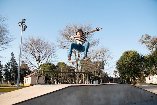 Skateboarder ollie trick in a ramp