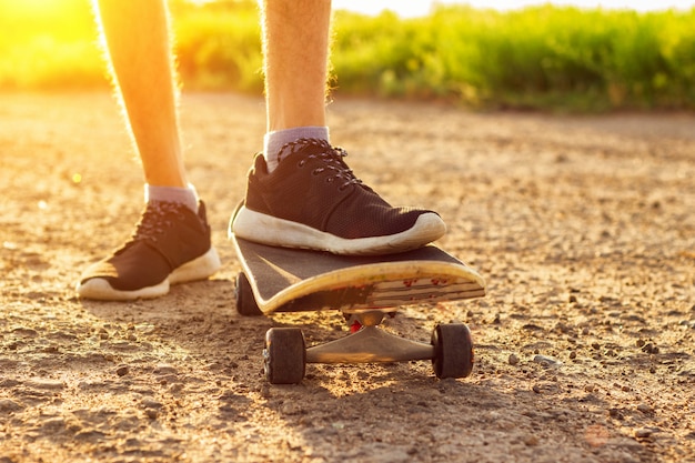 Skateboarding on the road at sunset , summer entertainment