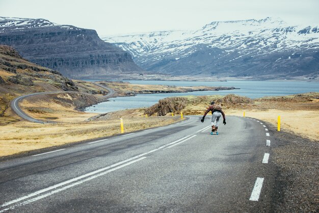 Skater traveling iceland on his longboard