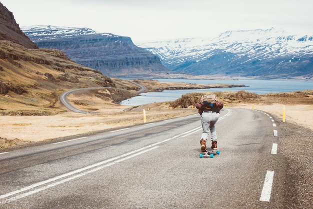 Skater traveling iceland on his longboard