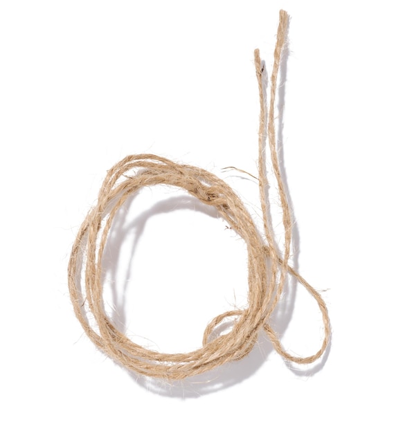 A skein of brown twine rope on a white isolated background top view Packing natural