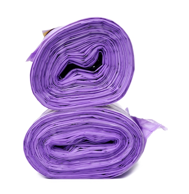 Skein of purple plastic trash bags with strings isolated on white background, close up