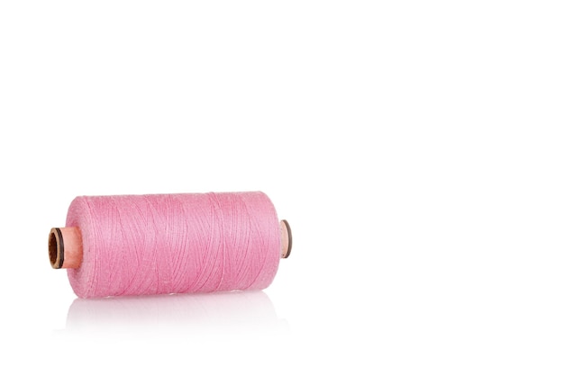 Skein of thread pink colors macro on a white background