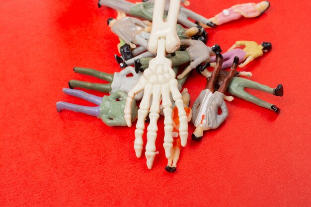 Skeleton hand pressing on people figurine Death concept