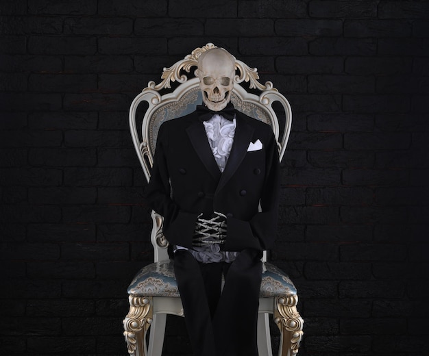 skeleton in a suit in a vintage chair