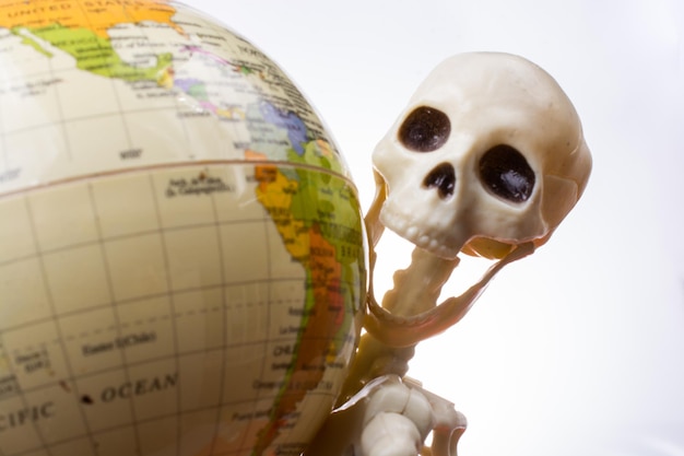 Skeleton with a globe in hands