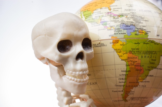 Skeleton with a globe in hands