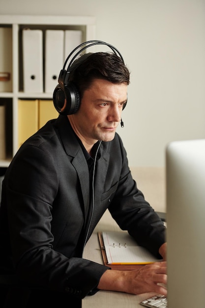 Skeptical Businessman Listening to Colleague
