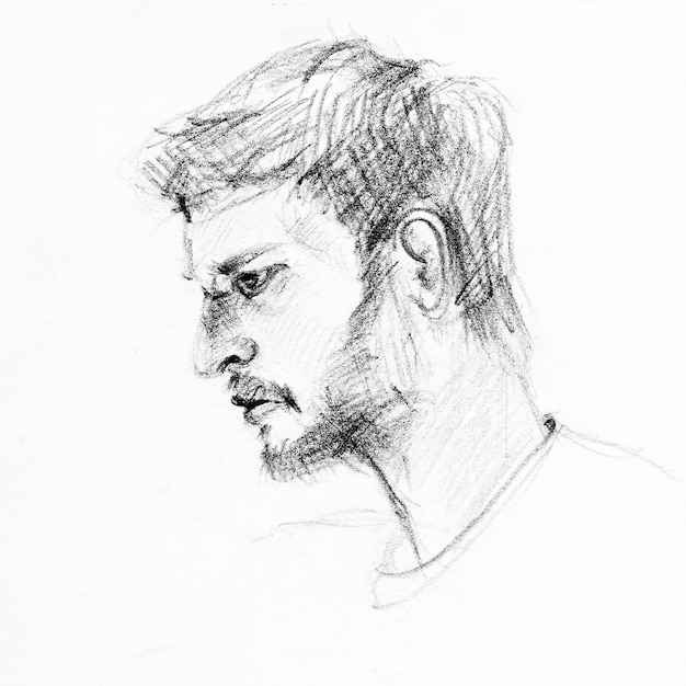 Photo sketch of side face of man drawing by hands with black pencil on white paper