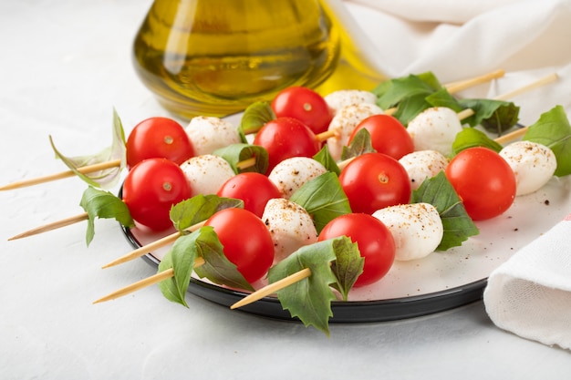 Skewer with tomato, mozzarella and basil.