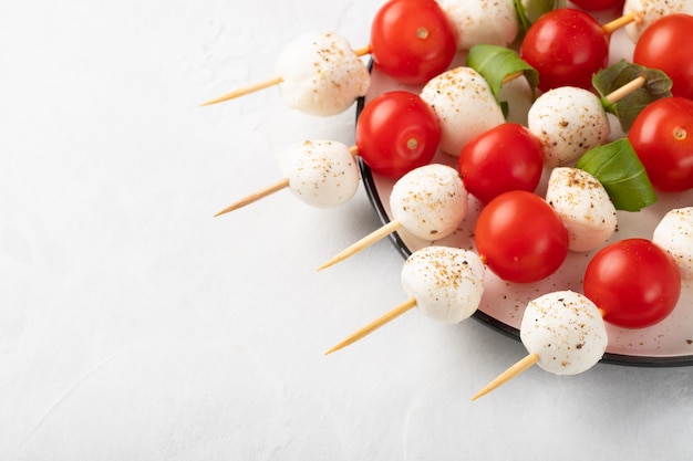 Skewer with tomato, mozzarella and basil.