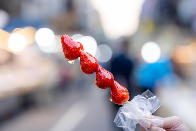 Skewered fruit with strawberry at street market