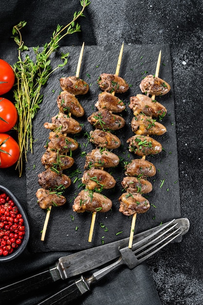 Skewered and grilled chicken hearts