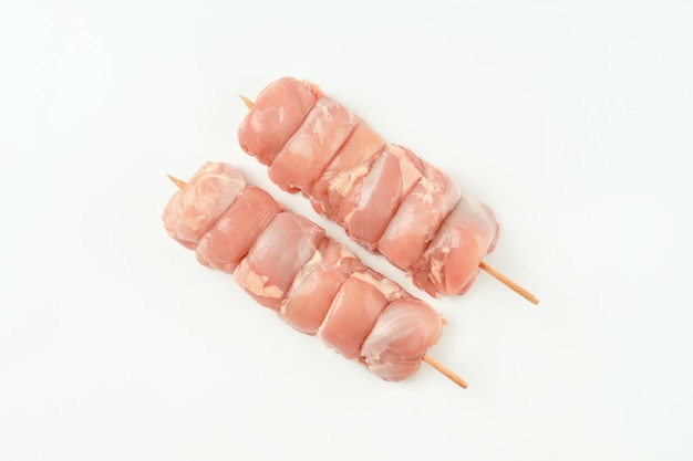 Skewers from raw chicken leg meat without skin for a supermarket on a white backgroundfood for retai