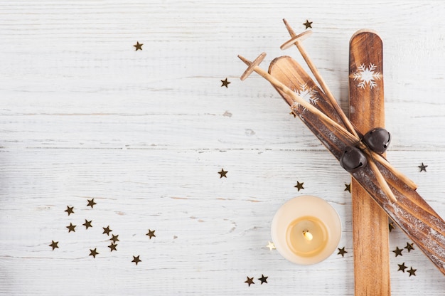 Ski decor with lit candle and golden stars