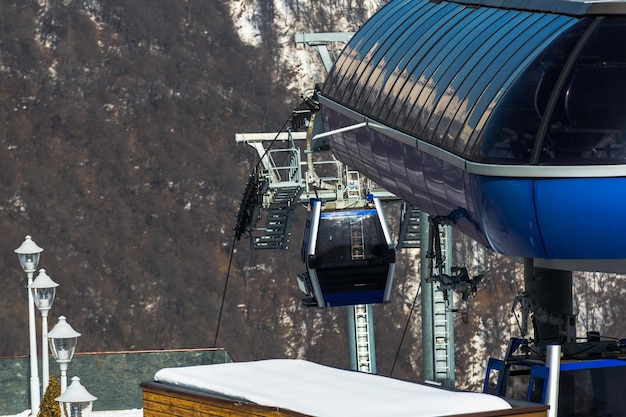 Ski lift cable ropeway and cableway transport system for skiers\
with fog on valley background