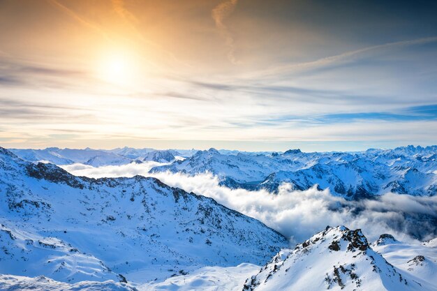 Ski resort in winter mountains. Top view. Val Thorens, 3 Valleys, France. Beautiful landscape of mountains with clouds at sunset