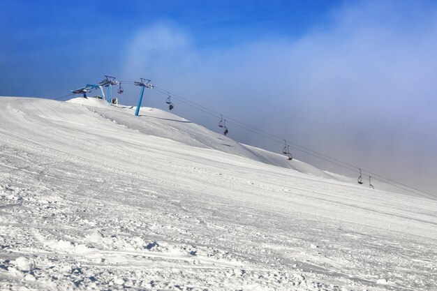 Ski slope at snowy resort on winter day