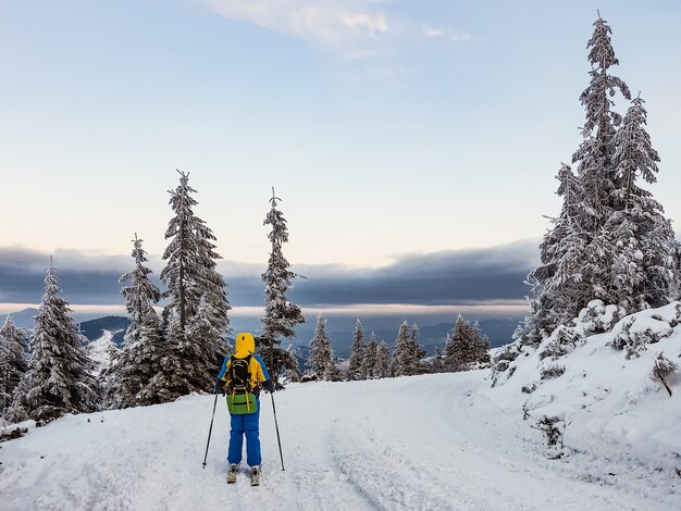 Ski tour woman skier on the top of the mountains copy space