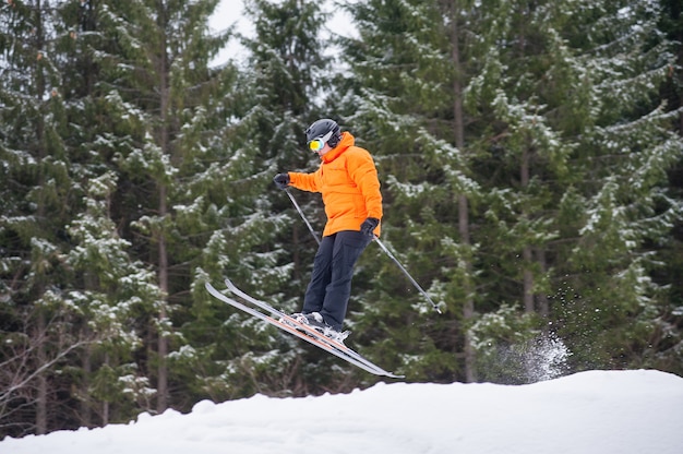 Skier at jump from the slope of mountains